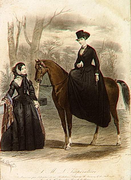 A woman wearing a black dress sitting on a horse